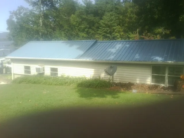 Blue metal roof running the length of a single story home in Monroe Bridge