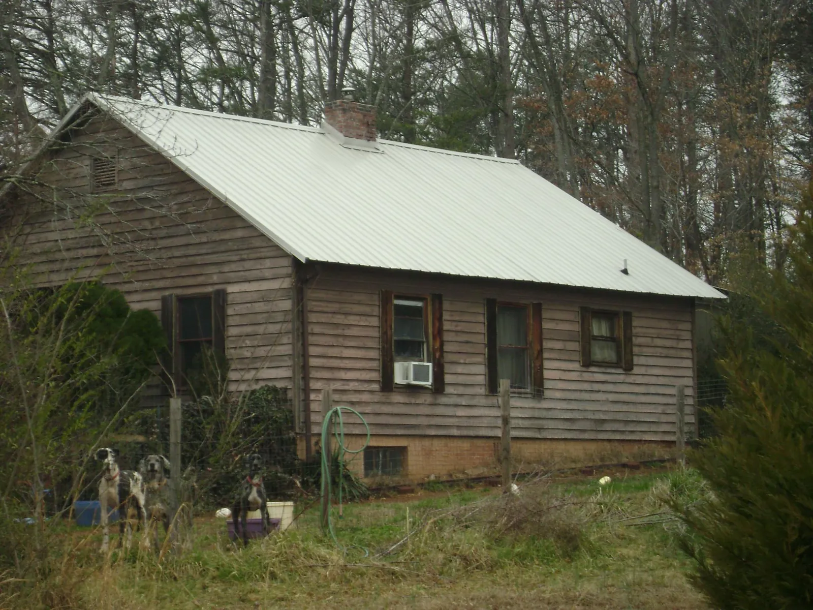 White metal roof on an old wood sided farmhouse, from a Metal Roof Installation job in Monroe Bridge